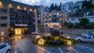 a parking lot in front of a building at Hotel Butua Residence in Budva