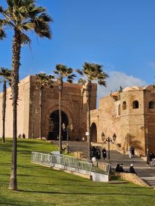 a building with palm trees in front of it at Sky View by Luxurious Holidays in Rabat
