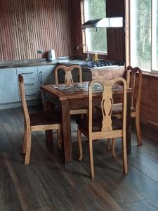 a wooden table and chairs in a kitchen at Casa acogedora in Castro