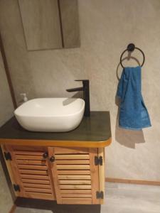 a bathroom with a white sink on a counter at Casa acogedora in Castro