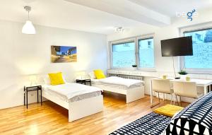 a living room with two beds and a table at BEGE APARTMENTS CitySleep in Aachen