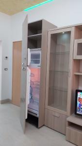 an empty refrigerator with its door open in a room at Alisia Apartment in Rossano Stazione +15 photos