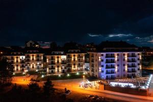 a group of buildings at night with lights at Apartman Mireli in Zlatibor