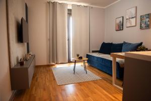a living room with a blue couch and a table at Apartman Mireli in Zlatibor
