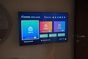 a flat screen tv hanging on a wall at Apartman Mireli in Zlatibor +7 photos