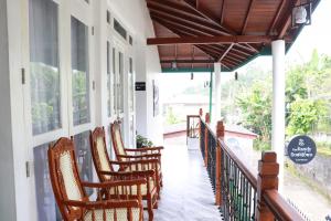 a row of chairs sitting on a porch at The kandy downtown in Katugastota