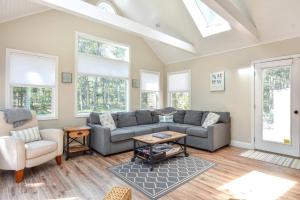a living room with a couch and a table at Large Great Location Dog Friendly in Dennis