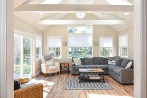 a living room with a couch and a table at Large Great Location Dog Friendly in Dennis