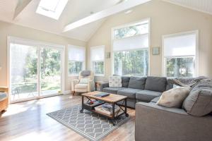 a living room with a couch and a table at Large Great Location Dog Friendly in Dennis +25 photos