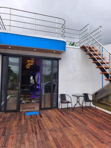 a patio with a table and chairs on top of a building at HOUSEBOAT AFFA grup in Karanganyar