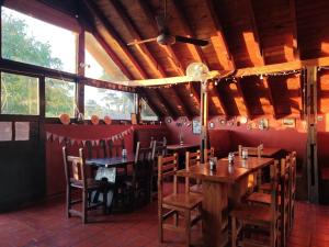 a dining room with wooden tables and chairs at Las Grullas in Villa Gesell