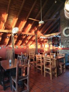 a dining room with wooden tables and chairs at Las Grullas in Villa Gesell