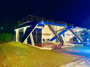 a house with a blue staircase next to the water at HOUSEBOAT AFFA grup in Karanganyar +7 photos