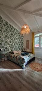 a bedroom with a bed and a chandelier at Villa Ulutawu in Le François +13 photos