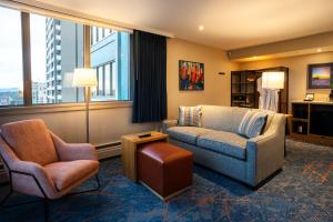 a living room with two chairs and a couch and a table at Blue Horizon Hotel in Vancouver