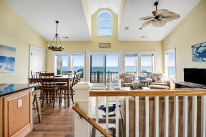 a living room and dining room with a view of the ocean at NTB3886 Soulshine-Sunshine-Moonshine in North Topsail Beach