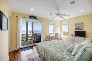 a bedroom with a bed and a view of the ocean at NTB3886 Soulshine-Sunshine-Moonshine in North Topsail Beach