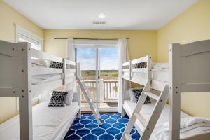 a room with bunk beds with a window and a balcony at NTB3886 Soulshine-Sunshine-Moonshine in North Topsail Beach +84 photos
