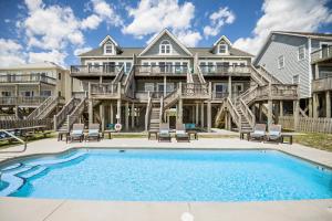 a large house with a swimming pool in front of it at NTB3886 Soulshine-Sunshine-Moonshine in North Topsail Beach