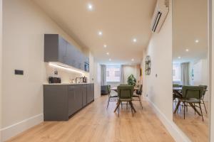 a kitchen and dining room with a table and chairs at BILBAO RIVERSIDE by STAYNN APARTMENTS in Bilbao +75 photos