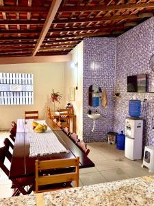 a dining room with a table and a kitchen at Pousada Sol Nascente in Morros