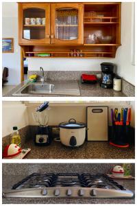 a kitchen counter with a stove and a sink at Suite Raya in Puerto Ayora