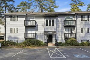 an empty parking lot in front of an apartment building at Cozy Downtown Stone Mountain Apartment in Stone Mountain