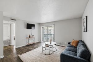 a living room with a blue couch and a table at Cozy Downtown Stone Mountain Apartment in Stone Mountain