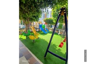 a playground with a slide and a swing at Spazio83 in Puerto Colombia