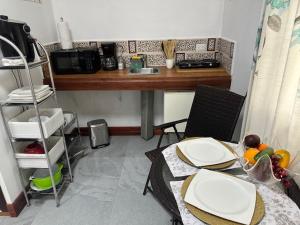 a kitchen with a table and a counter top at Virginia's apartaments in Omoa