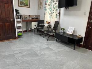 a living room with a table and chairs and a table at Virginia's apartaments in Omoa