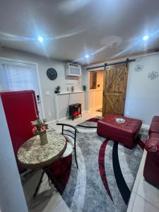 a living room with a red couch and a table at Cozy Cove in Lithonia