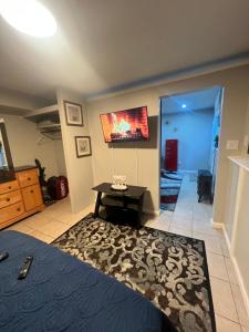 a bedroom with a bed and a table and a mirror at Cozy Cove in Lithonia