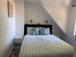a bedroom with a bed with two night stands and two lamps at Garden View near Confederation Bridge and Beaches in Borden-Carleton