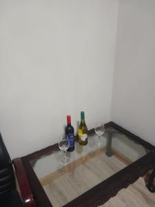 two bottles of wine and two glasses on a table at Donido's Place in Alberton