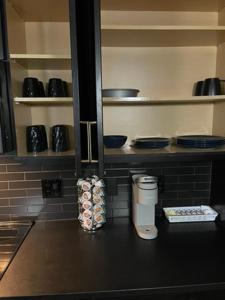 a kitchen with a counter with plates and bowls at Deep Ellum Lux in Dallas +5 photos