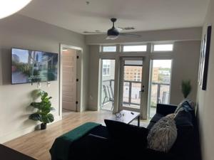 a living room with a couch and a large window at Deep Ellum Lux in Dallas