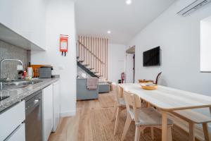 a kitchen and dining room with a table and chairs at Portas da Villa in Miranda do Douro