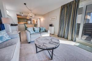 a living room with a couch and a table at Sea Pointe 2BR Condo Oceanview, Views, Large Condo in Myrtle Beach