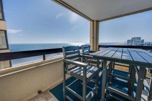 a table and chairs on a balcony with the ocean at Sea Pointe 2BR Condo Oceanview, Views, Large Condo in Myrtle Beach