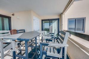 a blue table and chairs on a balcony at Sea Pointe 2BR Condo Oceanview, Views, Large Condo in Myrtle Beach +57 photos