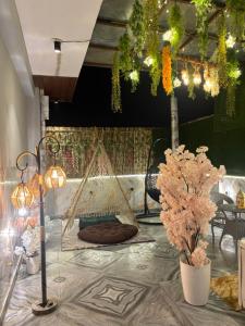 a room with a hammock and flowers on a table at The terrace affair studio with jacuzzi in Gurgaon +3 photos