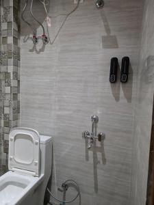 a bathroom with a white toilet and a sink at The terrace affair studio with jacuzzi in Gurgaon