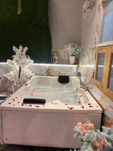 a bath tub filled with water in a room at The terrace affair studio with jacuzzi in Gurgaon