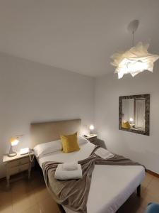 a bedroom with a bed and two tables and a mirror at El Sueño del Infante in Guadalajara +38 photos