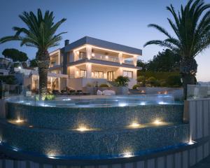 a villa with a swimming pool at night at Villa Kalliston - 4000m2 of Elevated Living in Rethymno