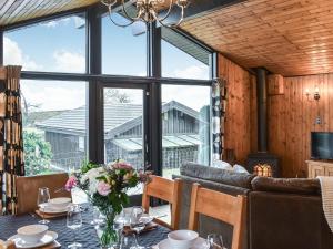 a dining room with a table and a large window at Glendowlin Lodge Retreat in Tirril