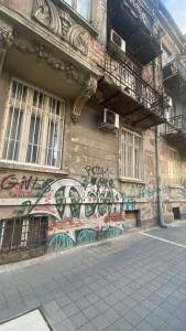 a building with graffiti on the side of it at Hello Sofia Guesthouse in Sofia