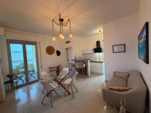 a living room with a couch and a table at La Perla Saba 2 in Montemarciano