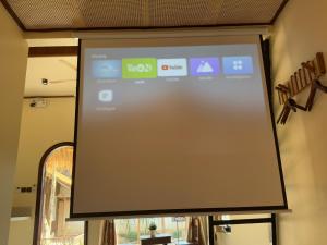 a projection screen on a wall in a room at The Hue Verandah in Thôn Trường Giang